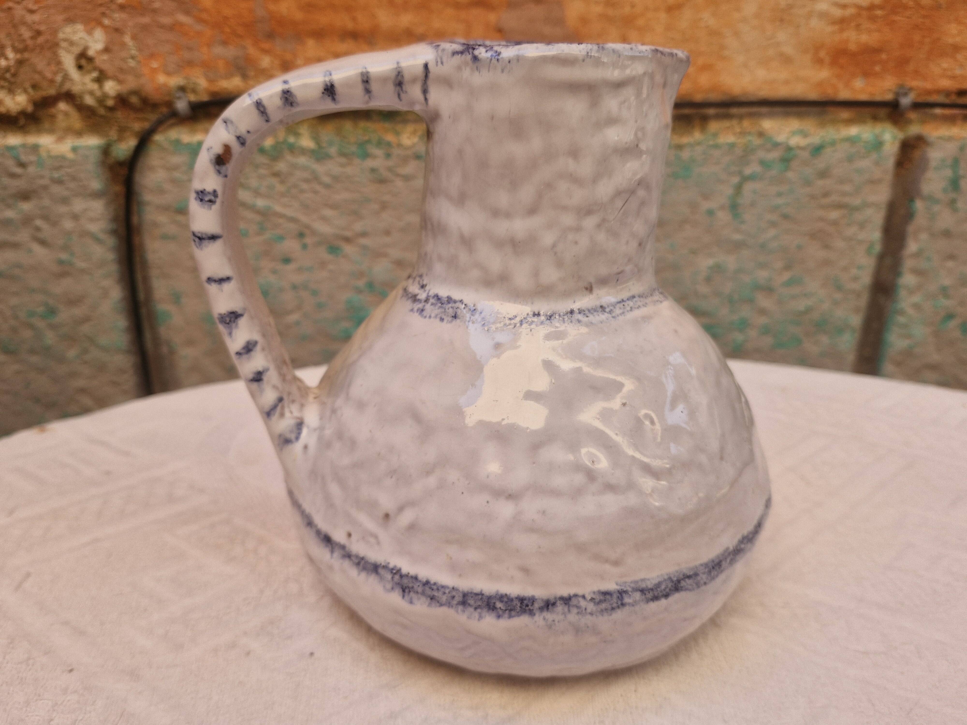Old stamped glazed terracotta jug