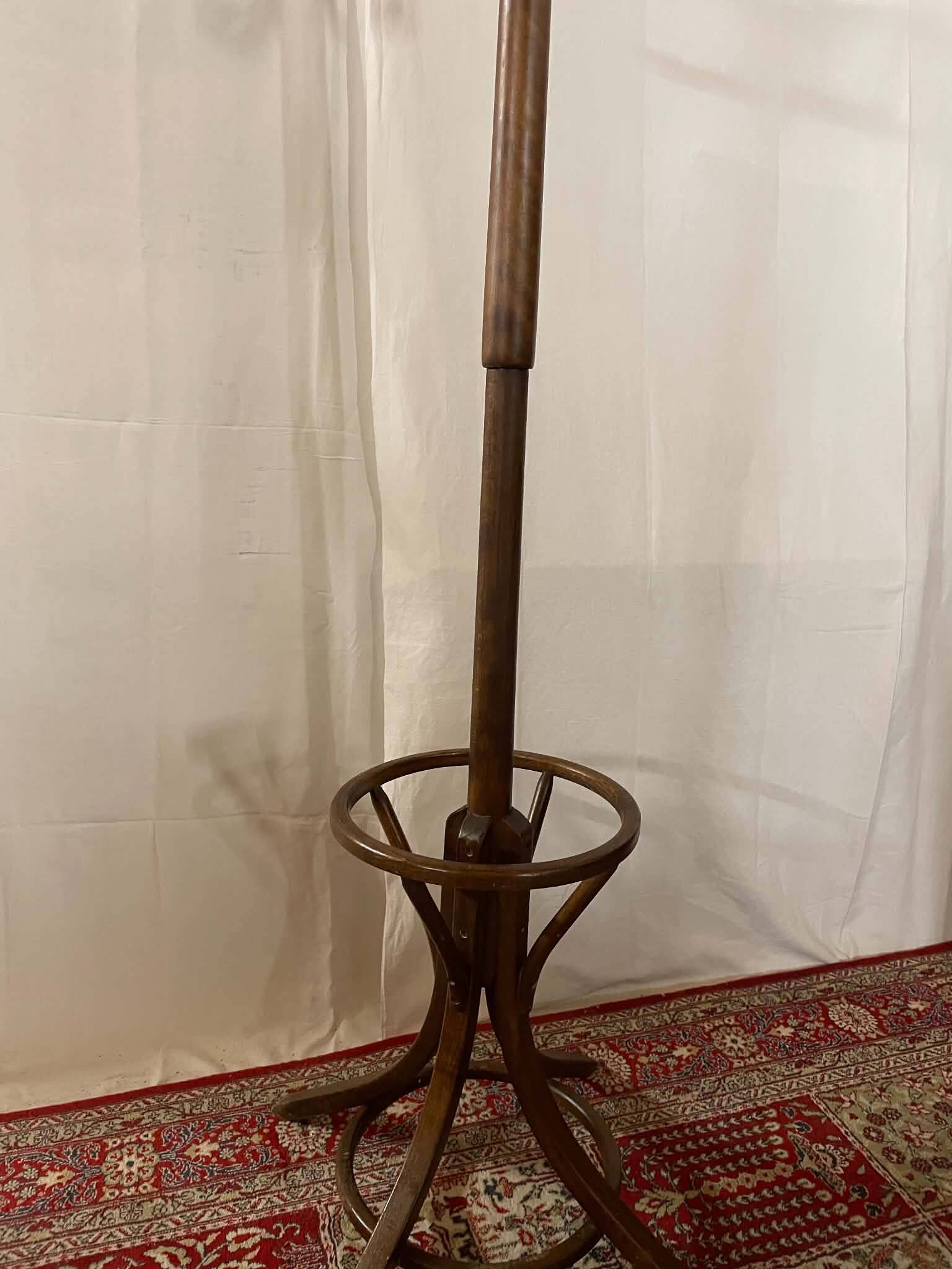 Antique curved wooden coat rack with umbrella stand.