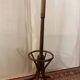 Antique curved wooden coat rack with umbrella stand.