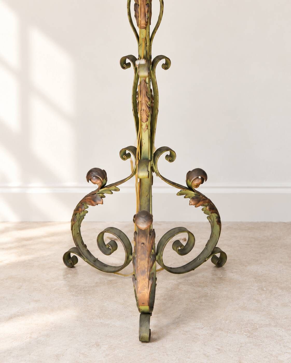 Antique green-painted iron floor lamp with a floral design.