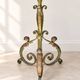 Antique green-painted iron floor lamp with a floral design.