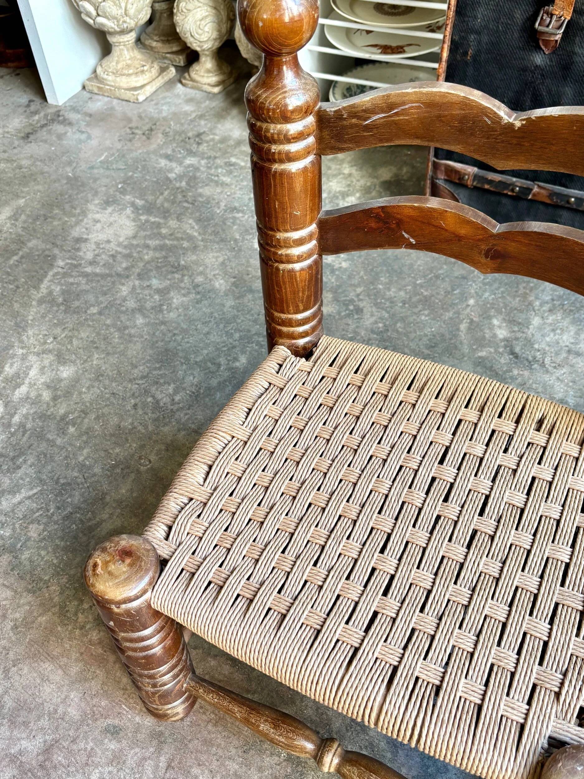 Low chair in dark wood and woven Danish cord attributed to Charles Dudouyt.