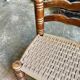 Low chair in dark wood and woven Danish cord attributed to Charles Dudouyt.