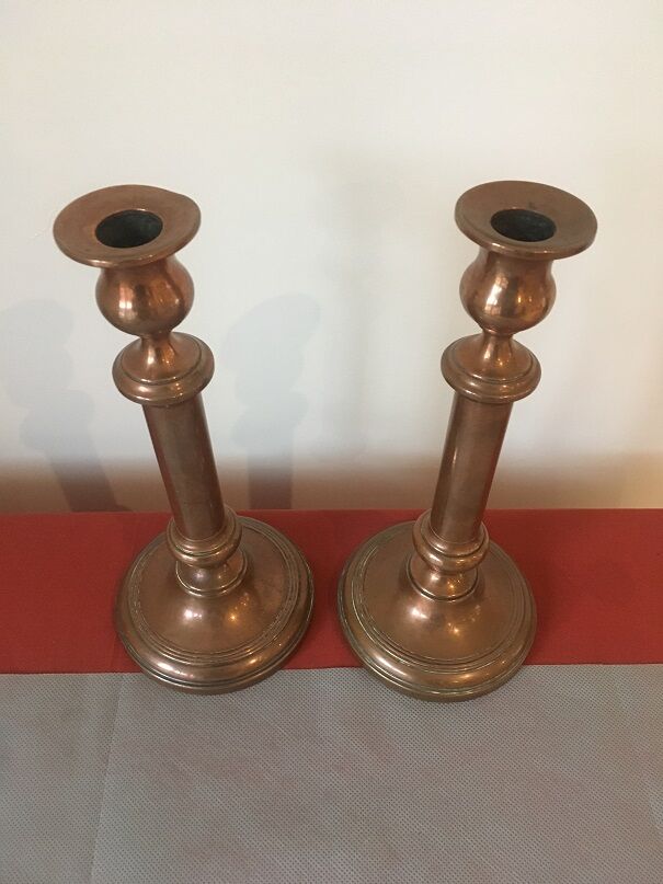 Pair of red brass candlesticks