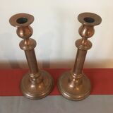Pair of red brass candlesticks