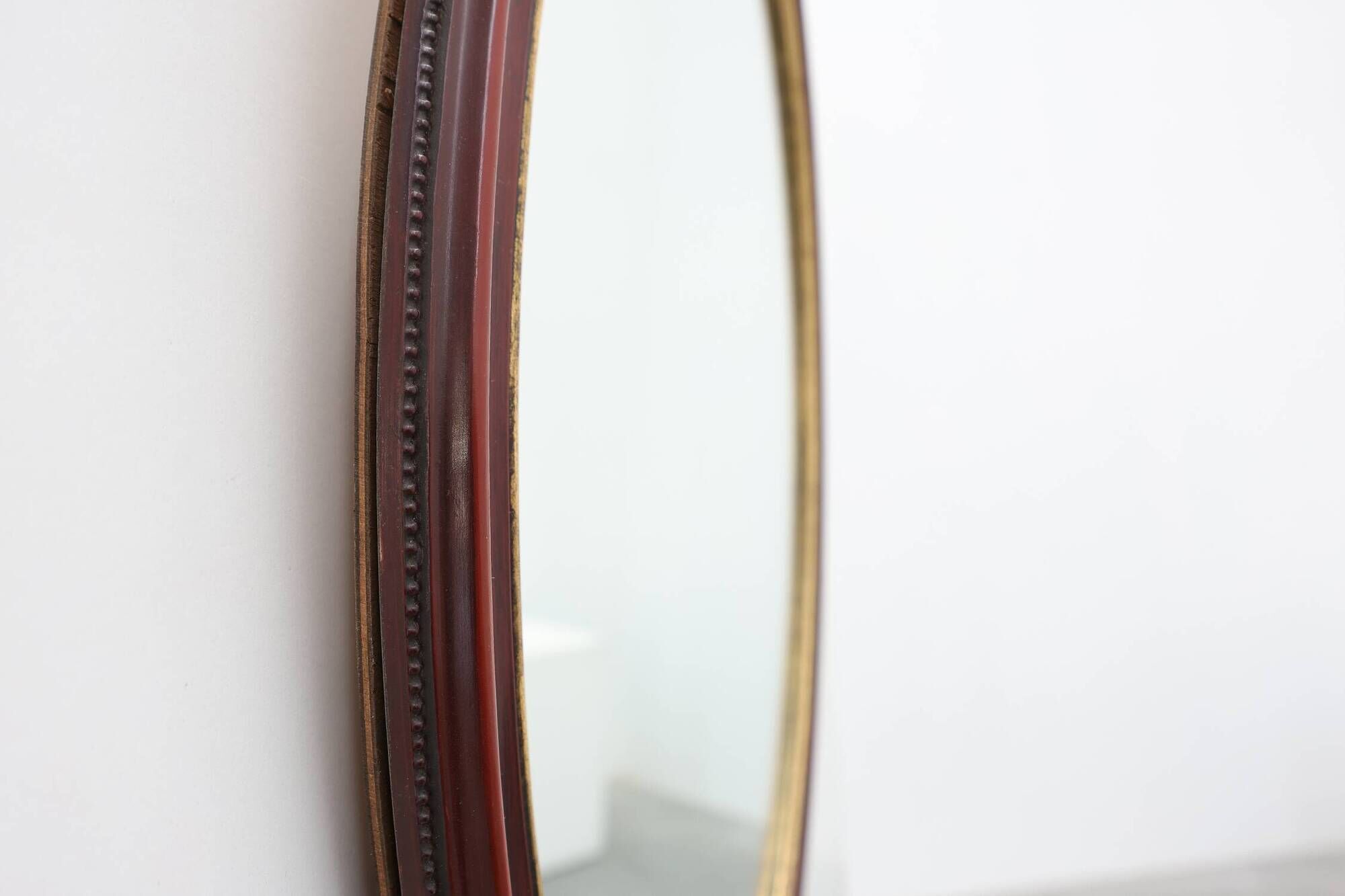 French Burgundy Lacquered Oval Mirror with Gilt Inner Edge, circa 1920