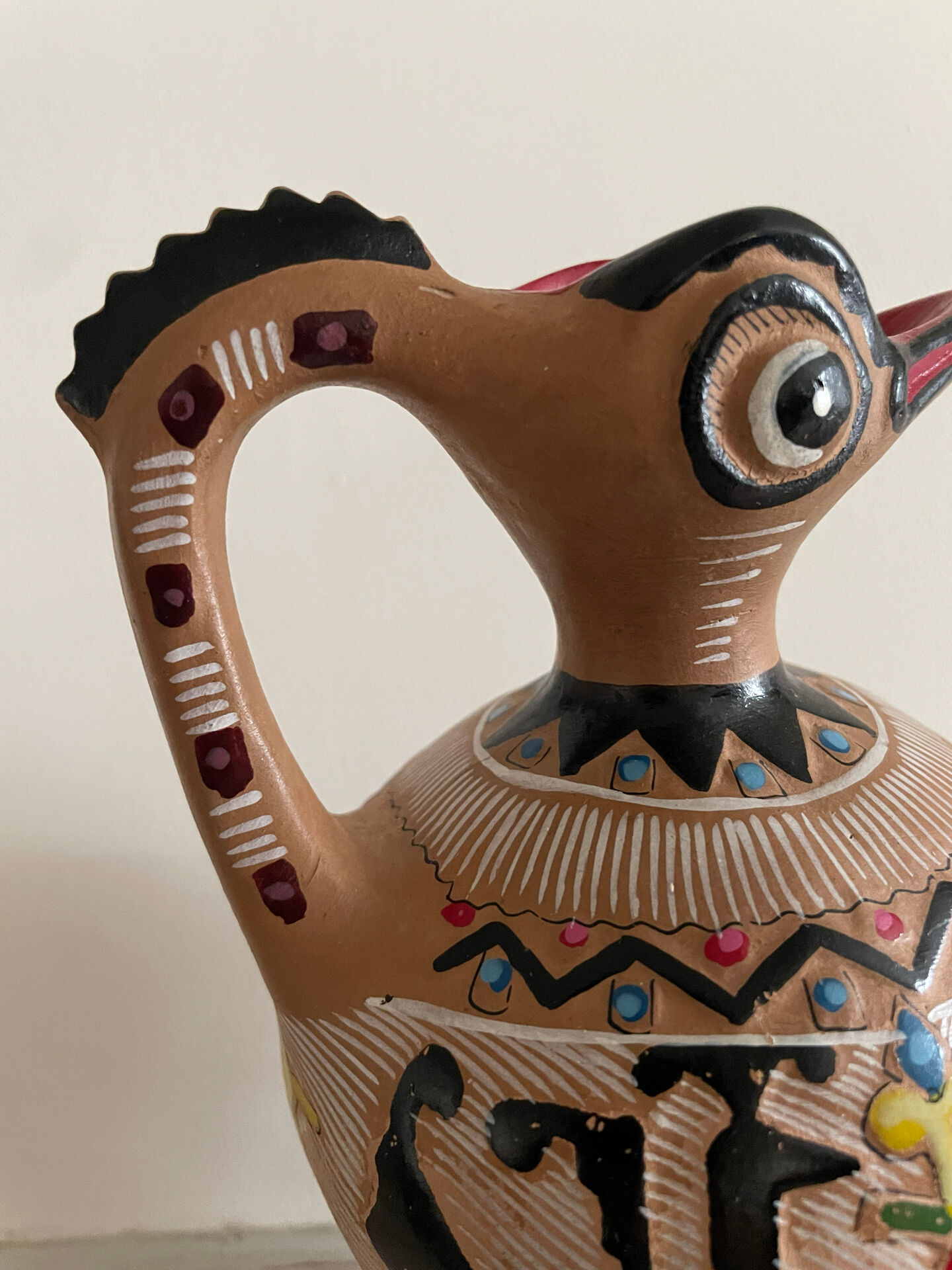 Clay pitcher with a bird head