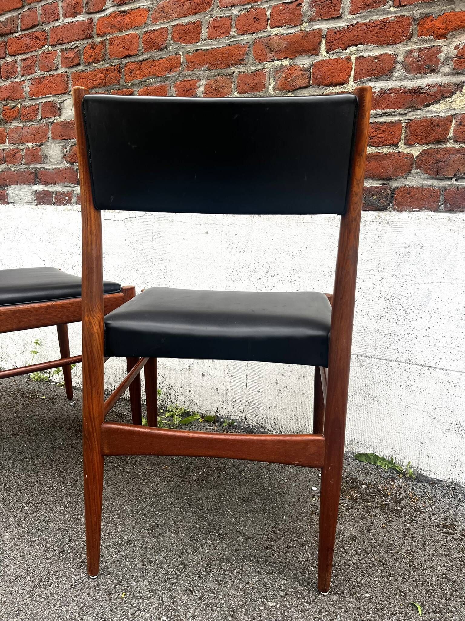 Set of 2 vintage Scandinavian chairs in wood and black faux leather.