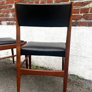 Set of 2 vintage Scandinavian chairs in wood and black faux leather.