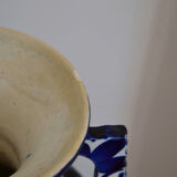 White hand-painted ceramic vase with blue patterns