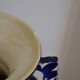 White hand-painted ceramic vase with blue patterns