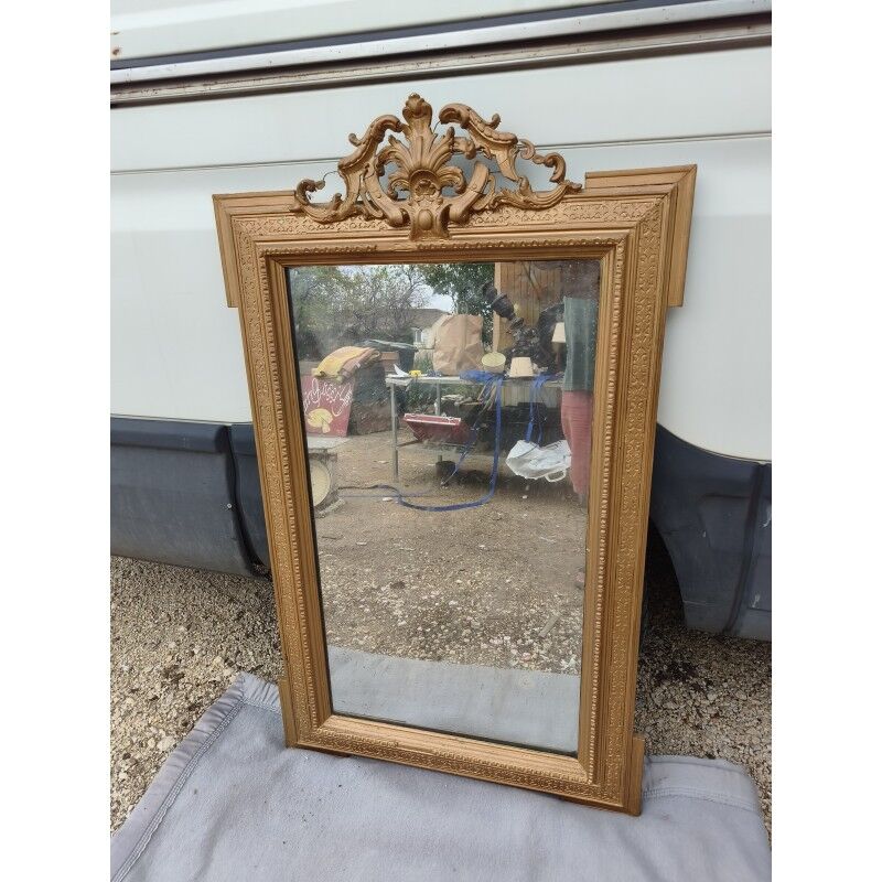 19th-century mirror in gilded wood and stucco.