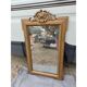 19th-century mirror in gilded wood and stucco.