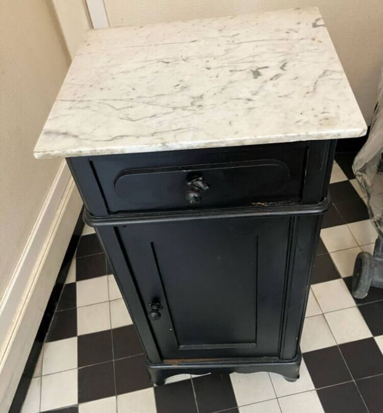 Chest of drawers with a white marble top.
