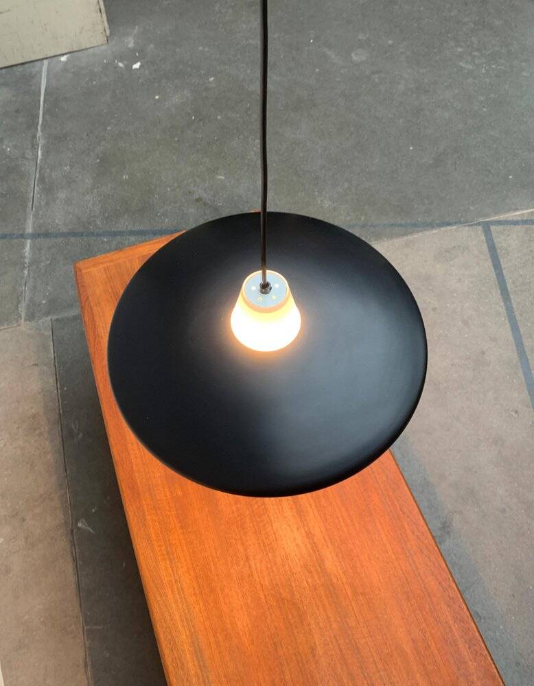 Minimalist metal and glass pendant lamp in mid-century style.