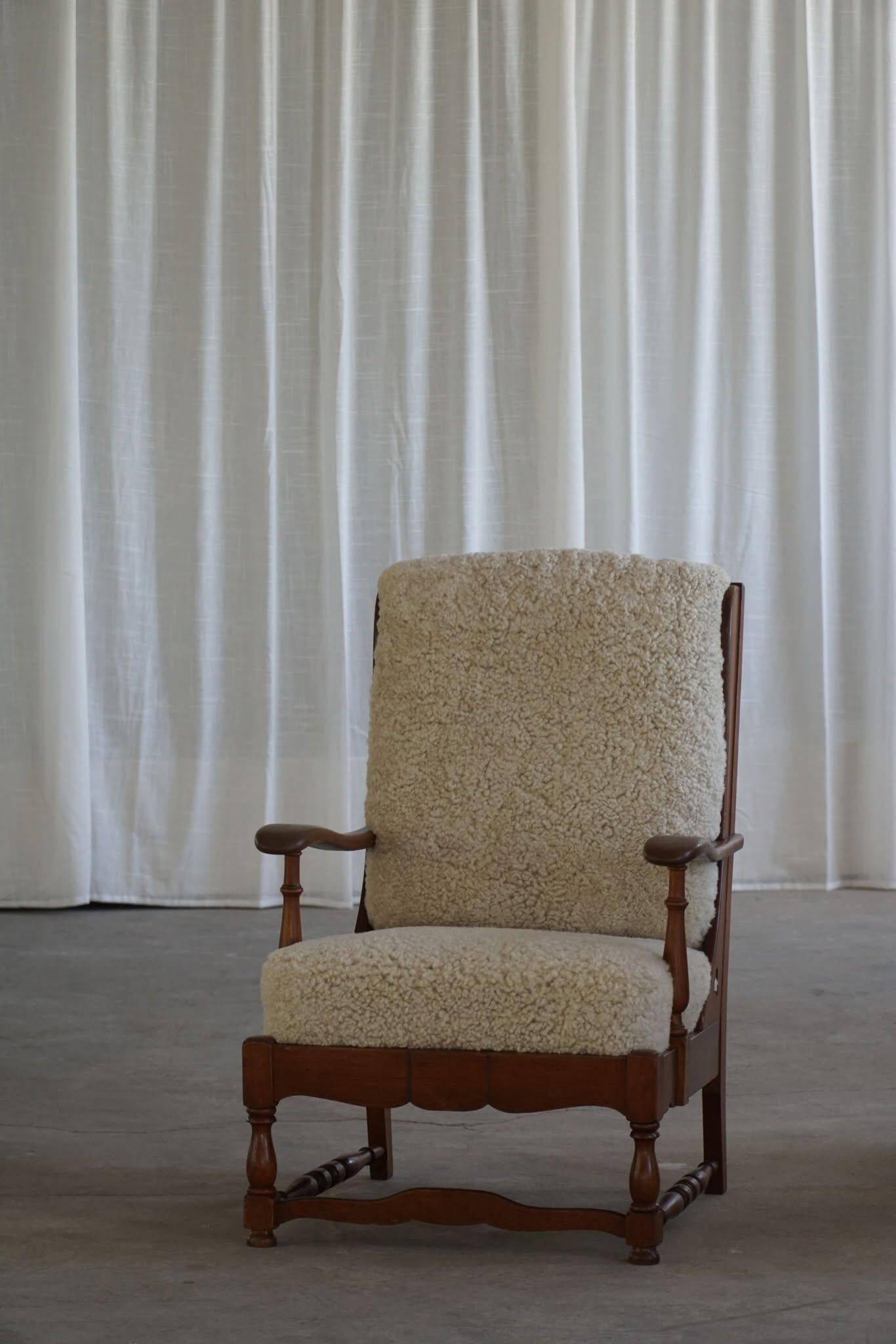 Modern Danish design, a pair of high-backed armchairs in oak and lambswool, 1950s.