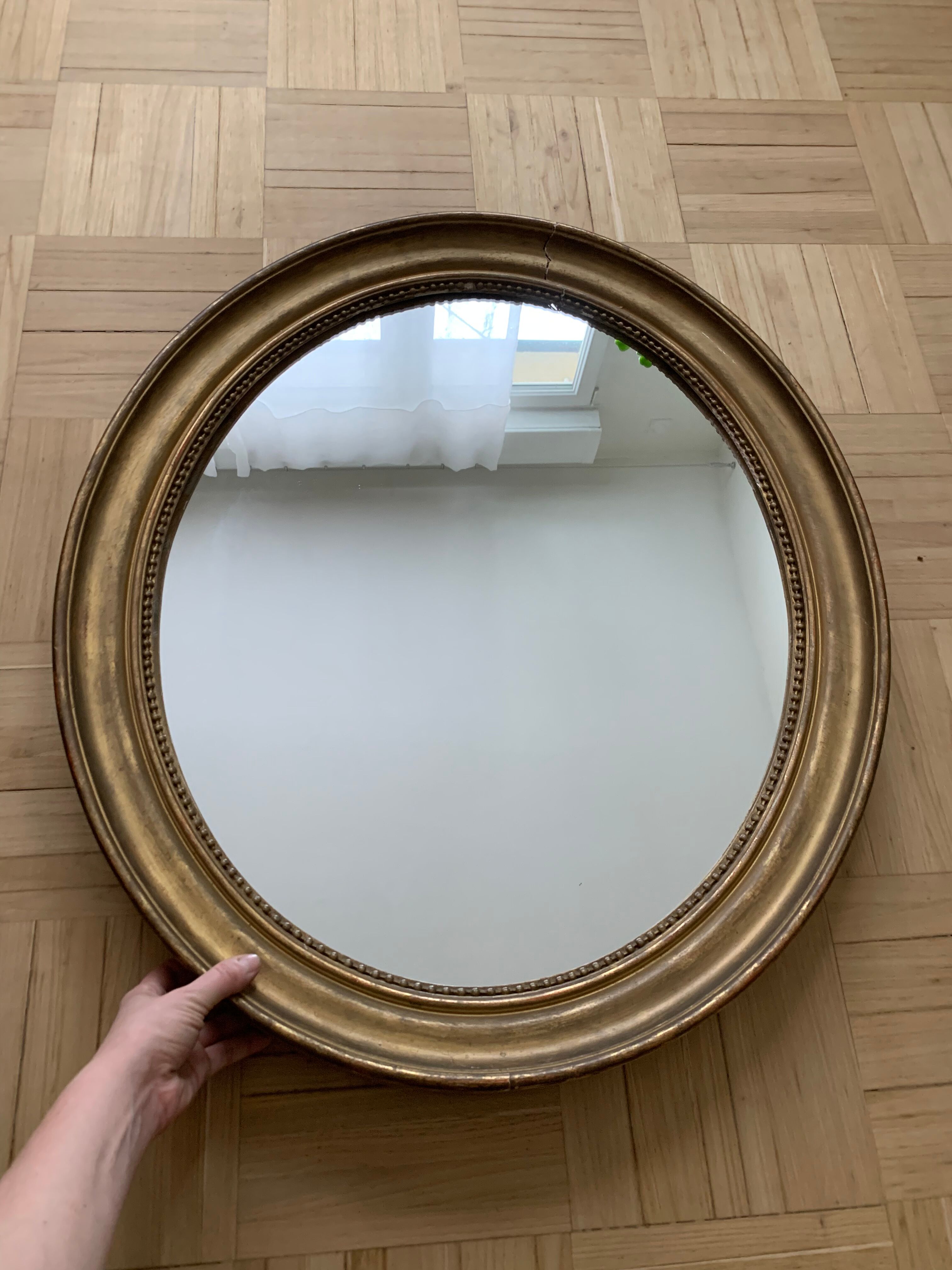 Old oval golden mirror