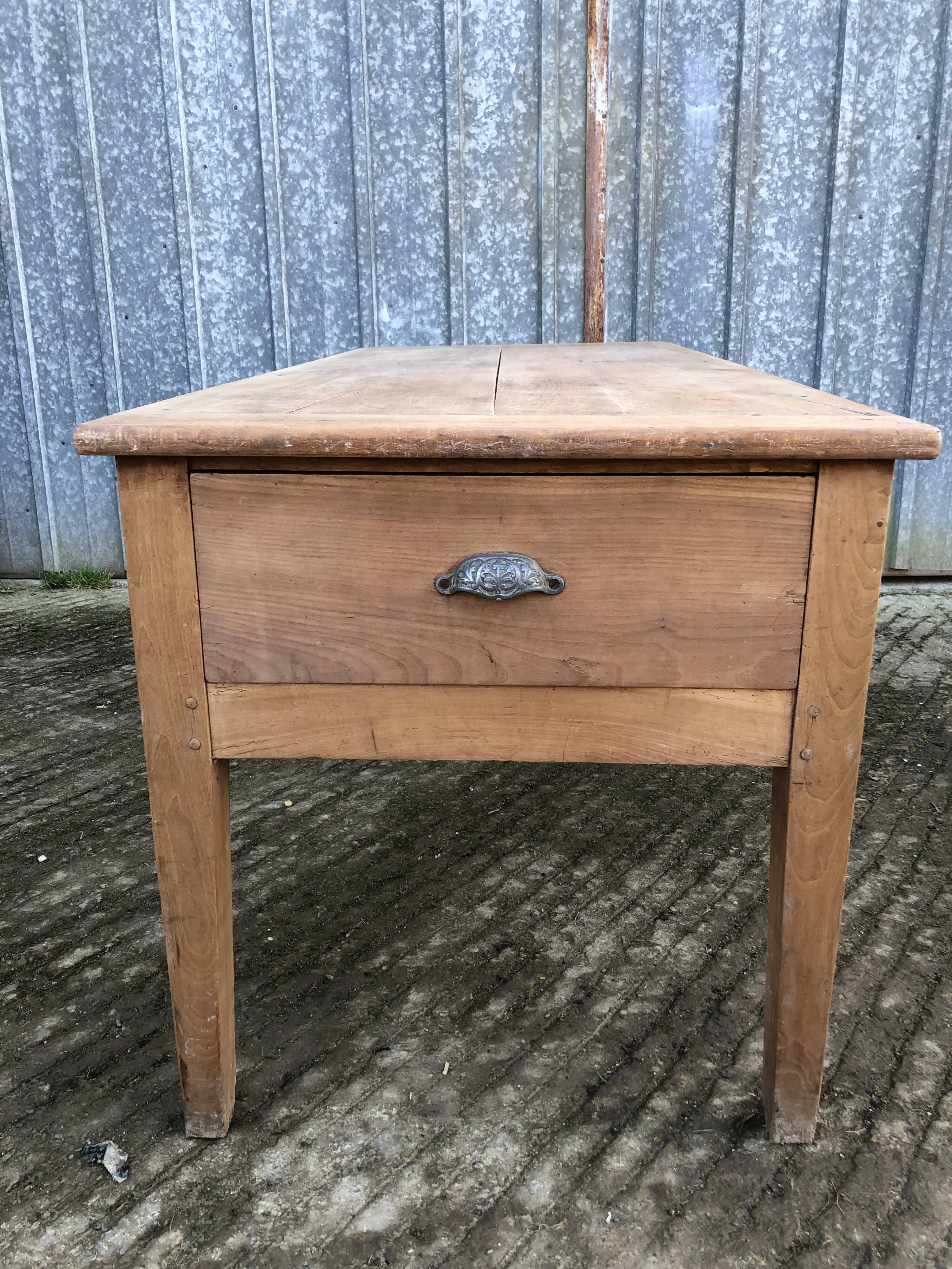 Antique solid cherry farmhouse table with 3 drawers and 1 pull out.