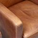 Pair of Art Deco armchairs in brown leather and teak, Netherlands, 1970s.