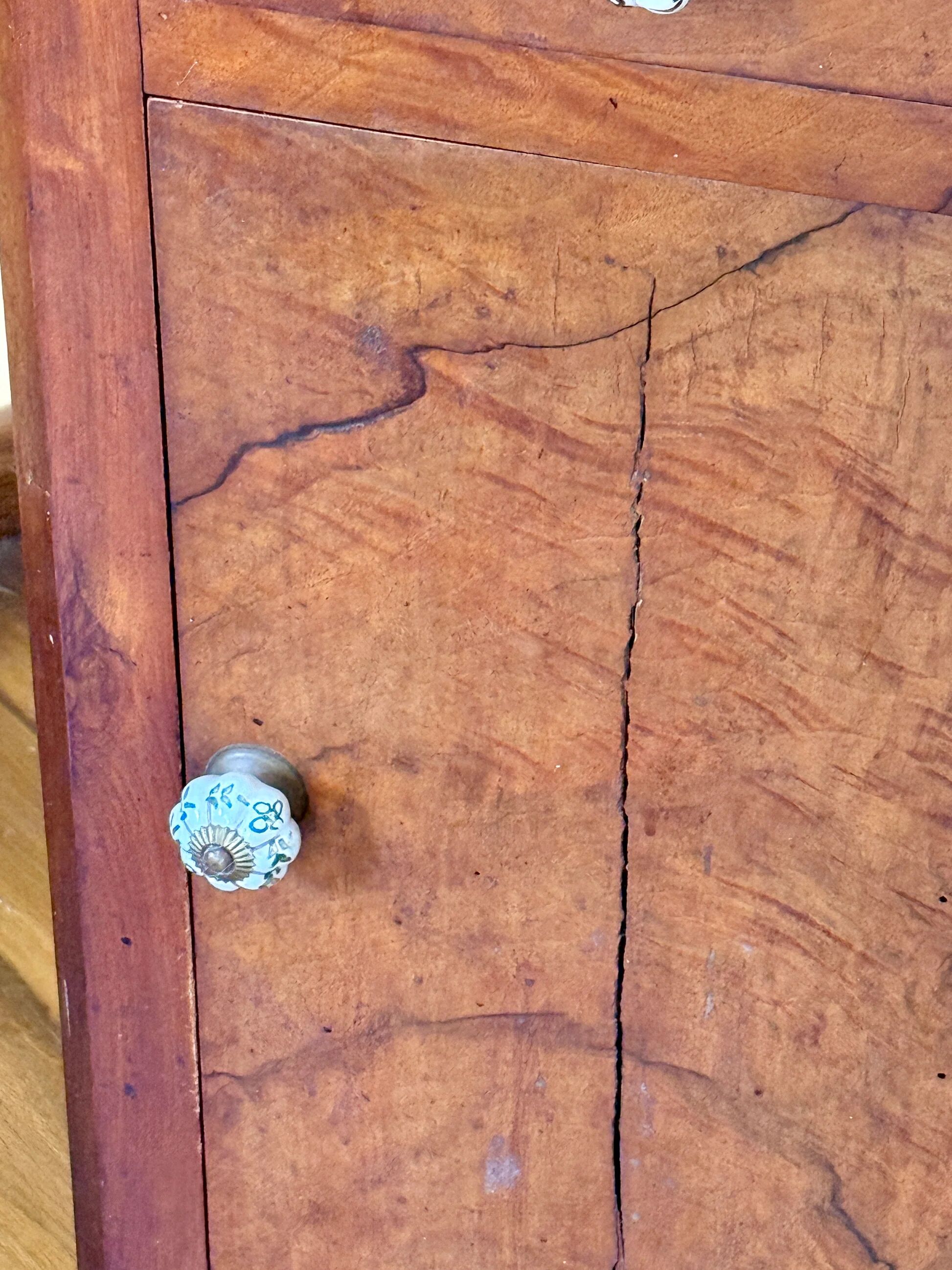 Wood and marble side table with ceramic handles.