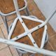 Set of four stackable industrial tubular metal and wood stools