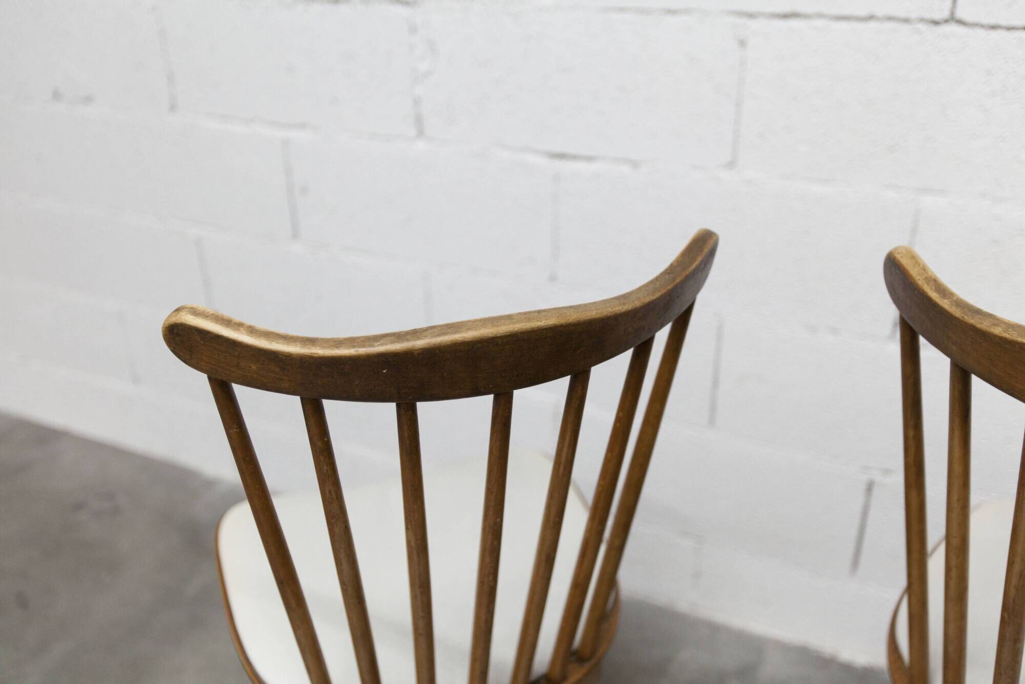 Pair of Baumann Menuet chairs, Honey patina, White skai seat