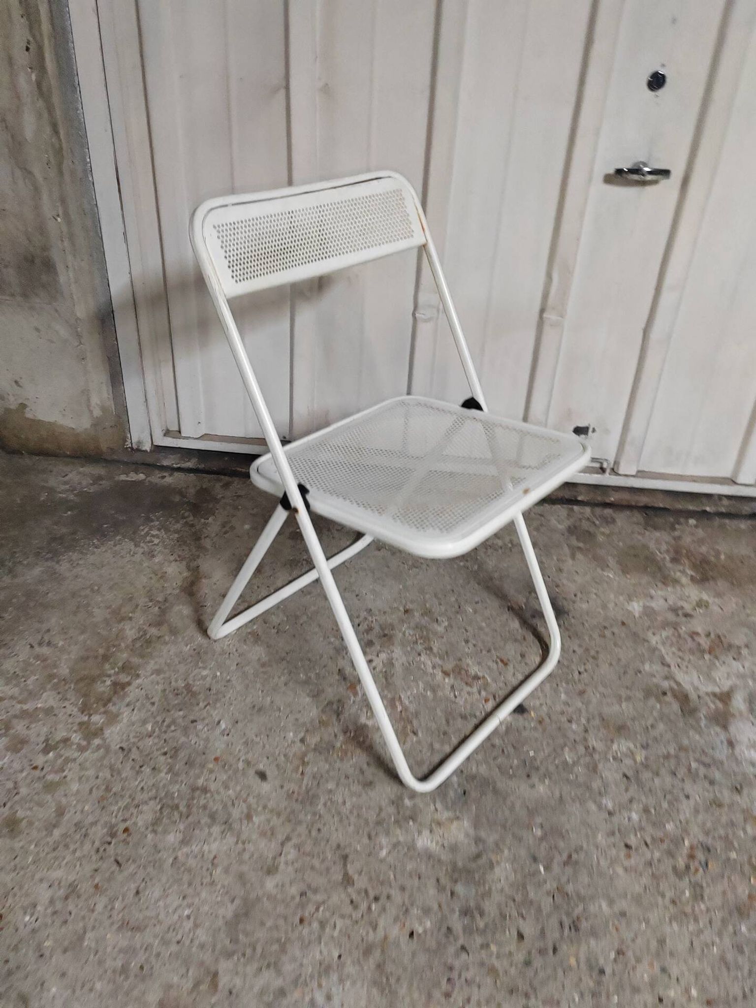 Perforated metal folding chair