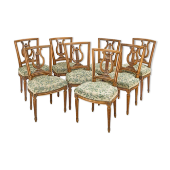 Suite of eight chairs in molded and carved wood