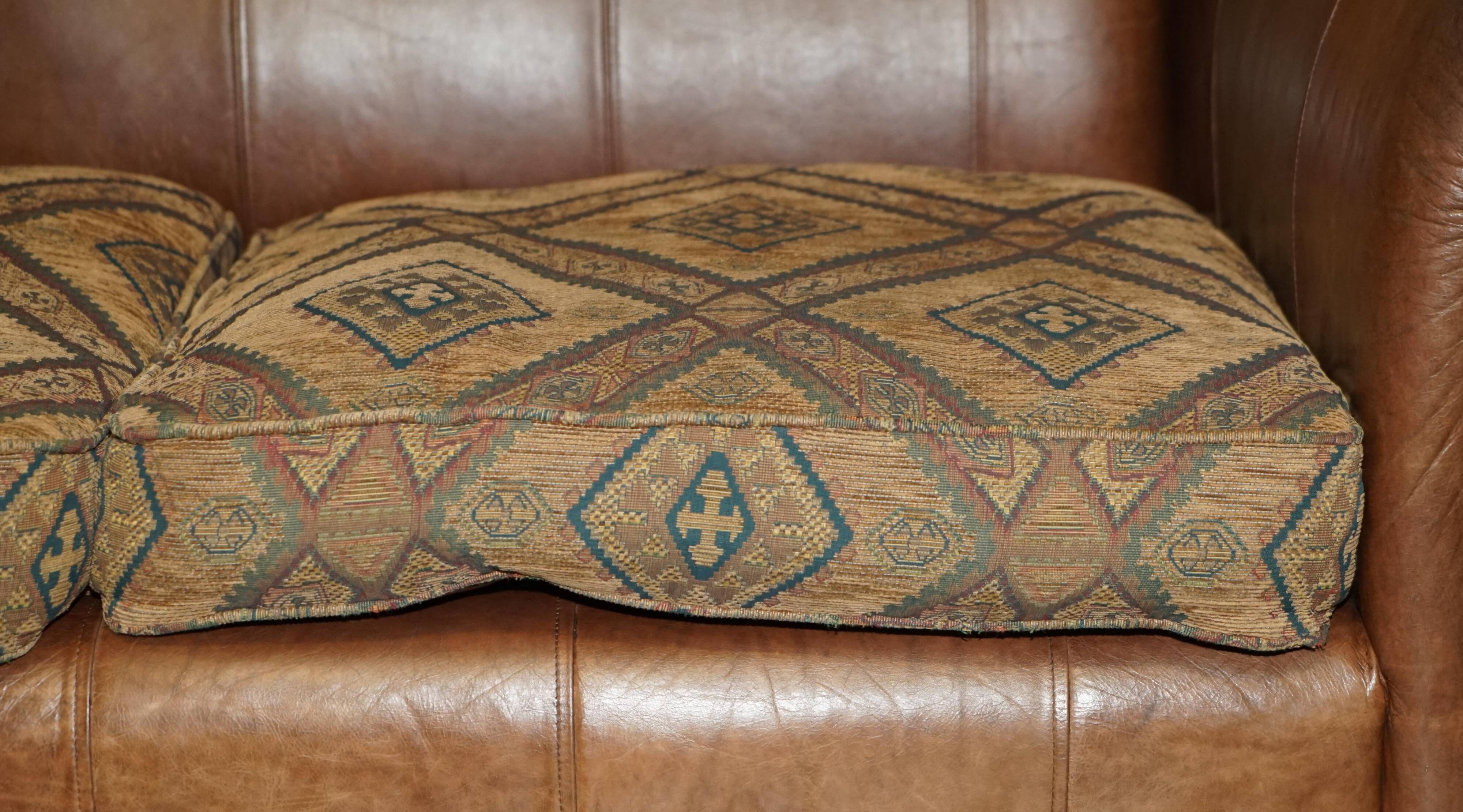Vintage leather sofas by Thomas Lloyd with Kilim cushions.