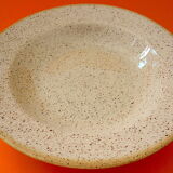 Suite of twelve speckled sandstone soup plates