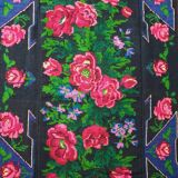 Handwoven floral wool rug, black background with pink roses