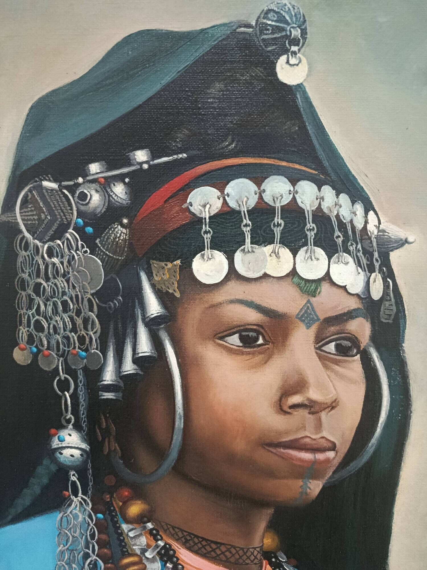 Portrait of a young Moroccan woman in traditional attire and adornments.