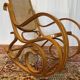 Antique rocking chair in curved wood and caning.