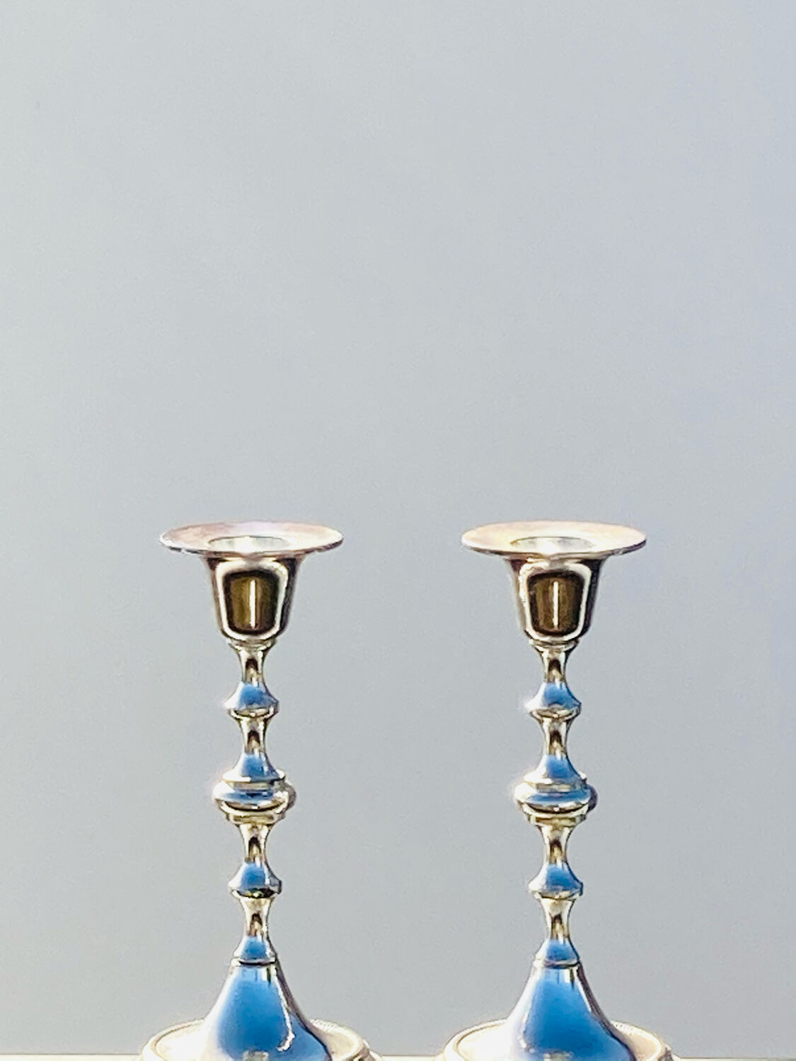 Two antique metal candle holders