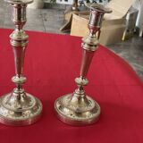 2 candlesticks with a chiseled floral decoration