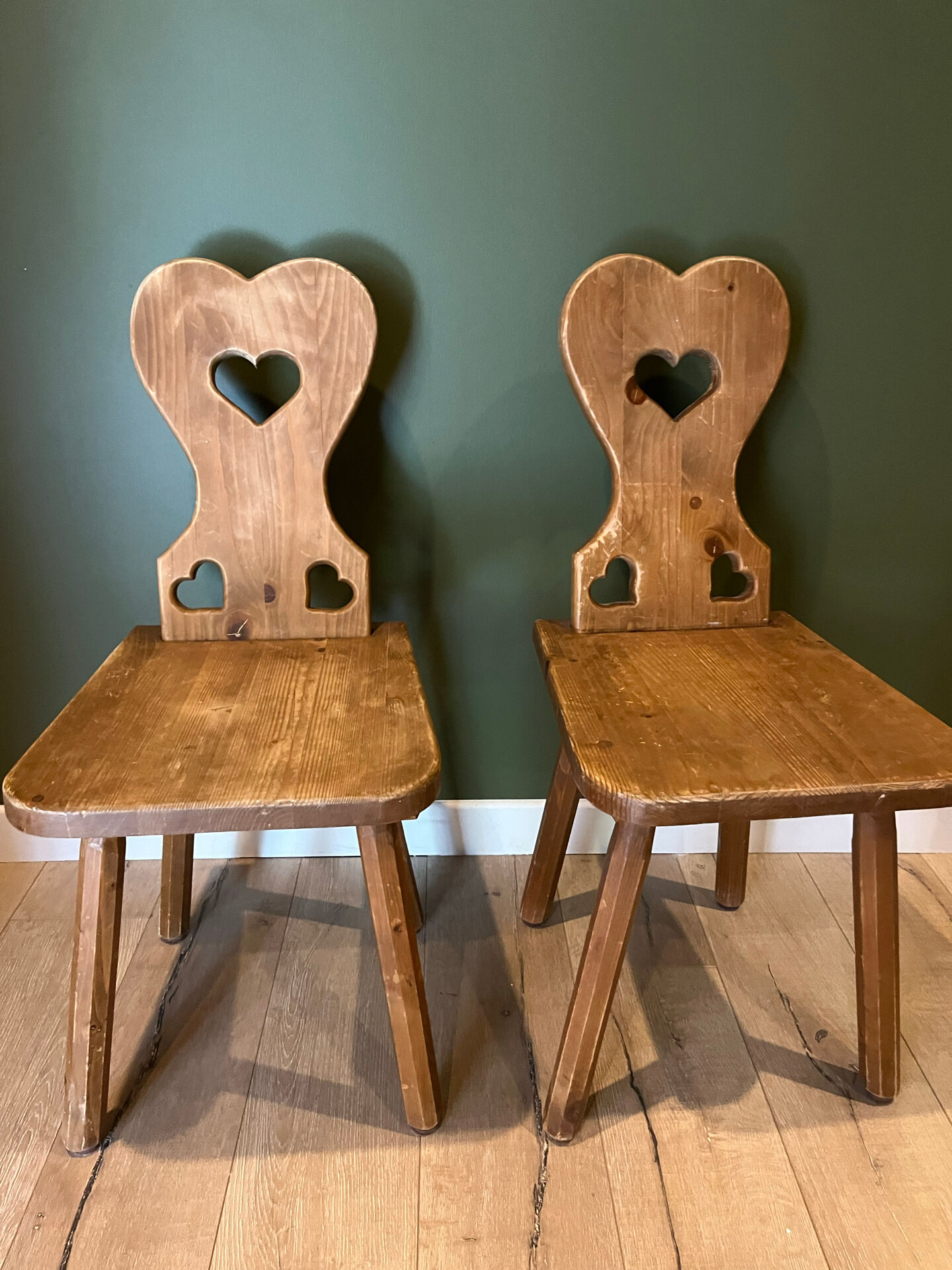 Pair of vintage wooden chairs in alpine chalet style.