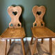 Pair of vintage wooden chairs in alpine chalet style.