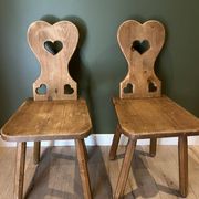 Pair of vintage wooden chairs in alpine chalet style.