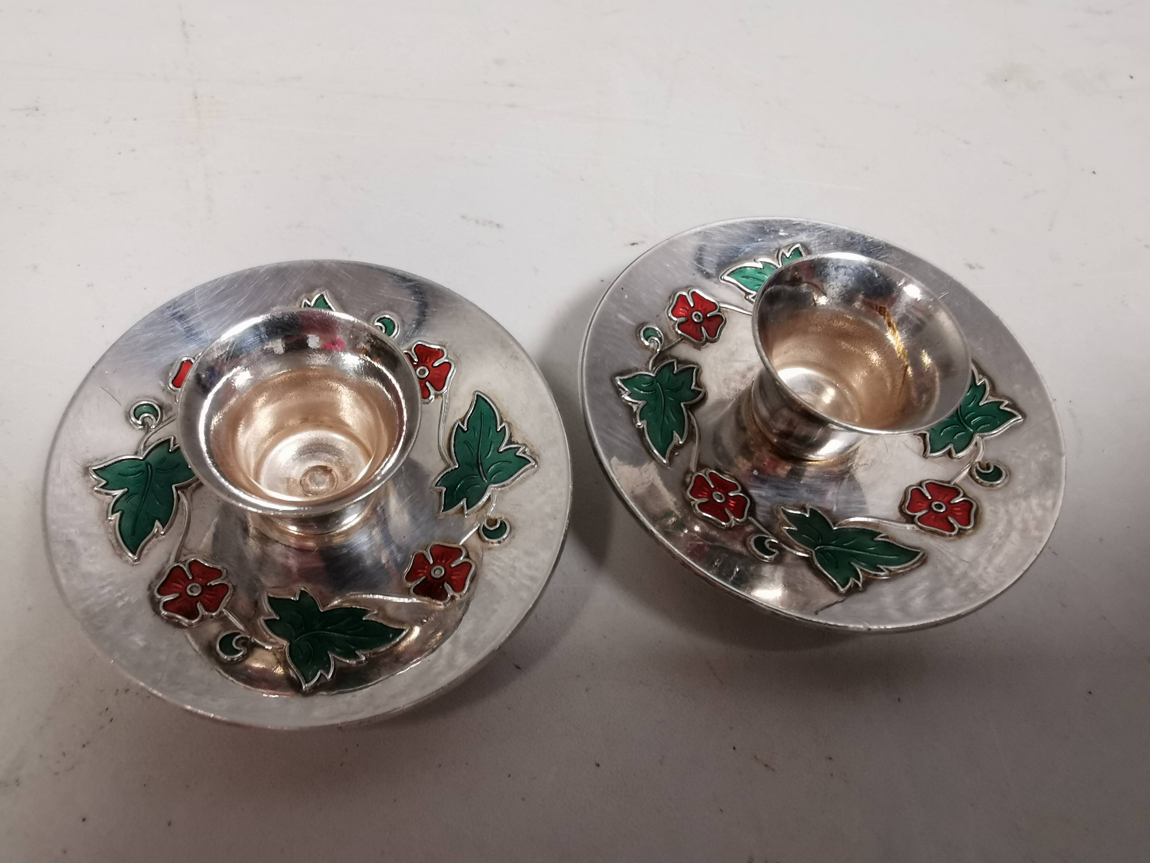 Silver-plated candle holders with inlaid red and green enamel