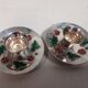 Silver-plated candle holders with inlaid red and green enamel