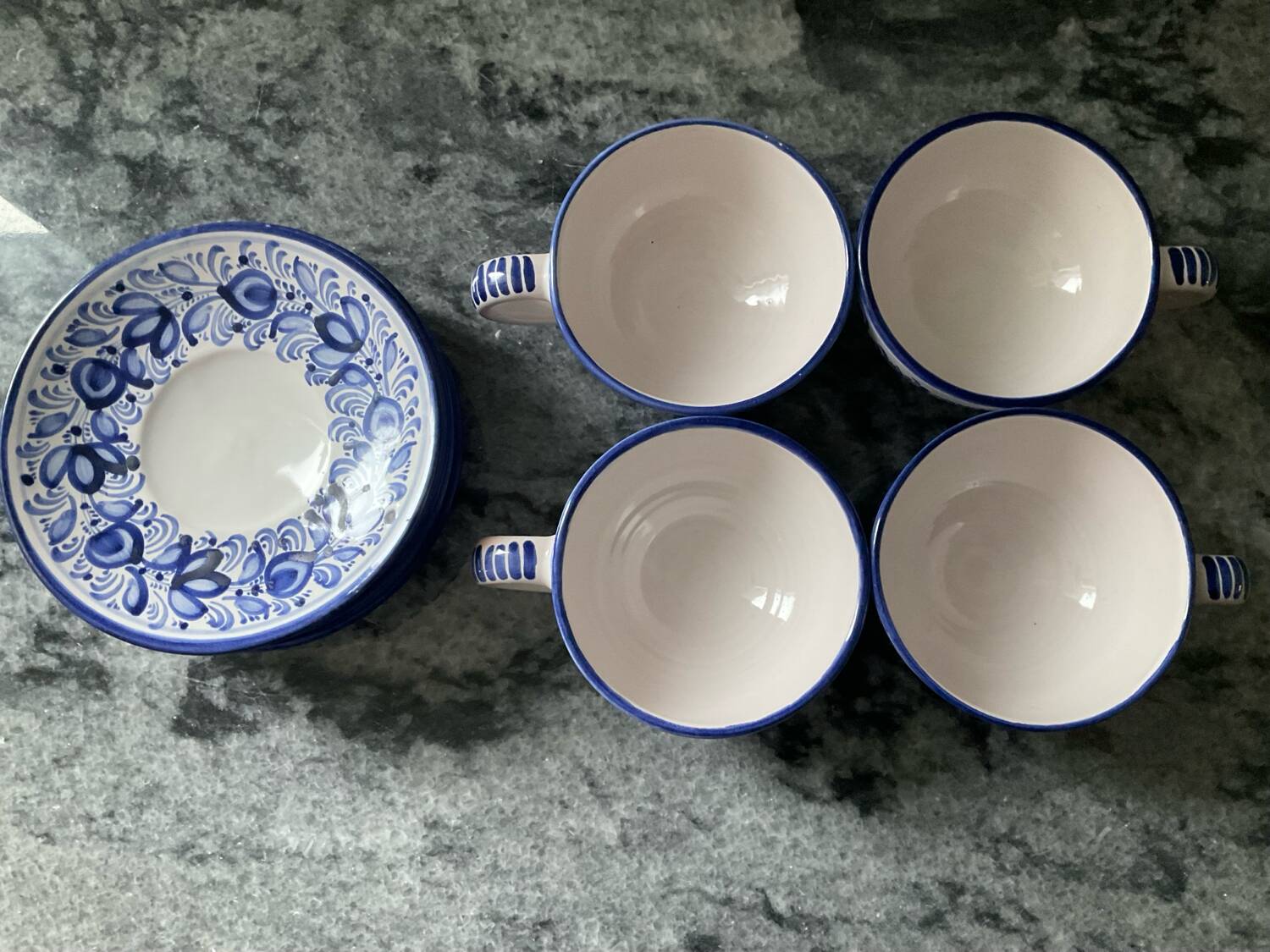 Set of 4 white/blue ceramic cups and saucers.