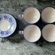 Set of 4 white/blue ceramic cups and saucers.