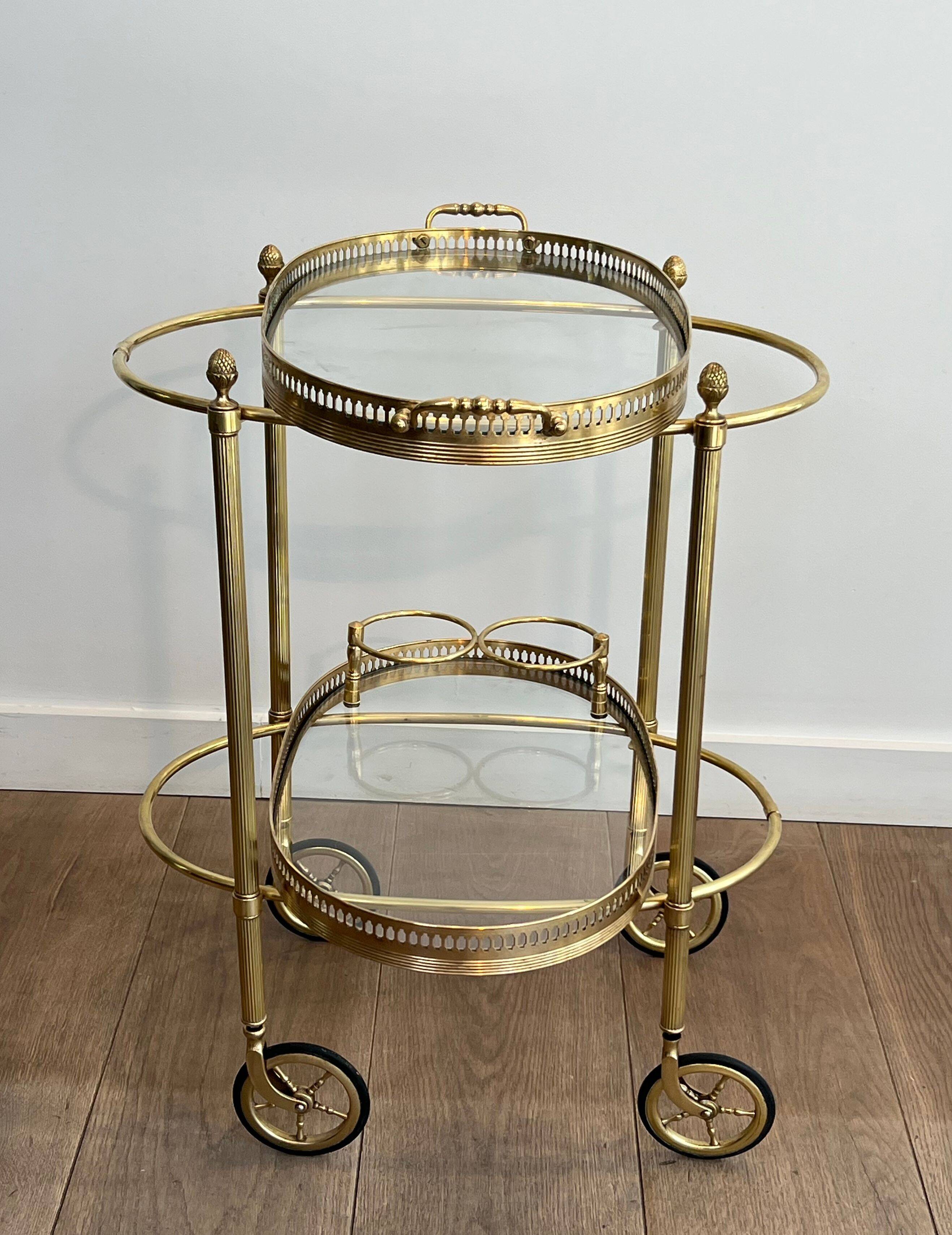 Small oval rolling table in brass with double removable trays from Maison Bagués.