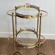 Small oval rolling table in brass with double removable trays from Maison Bagués.