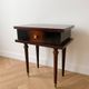 Vintage Art Deco bedside table in dark wood with gold details.
