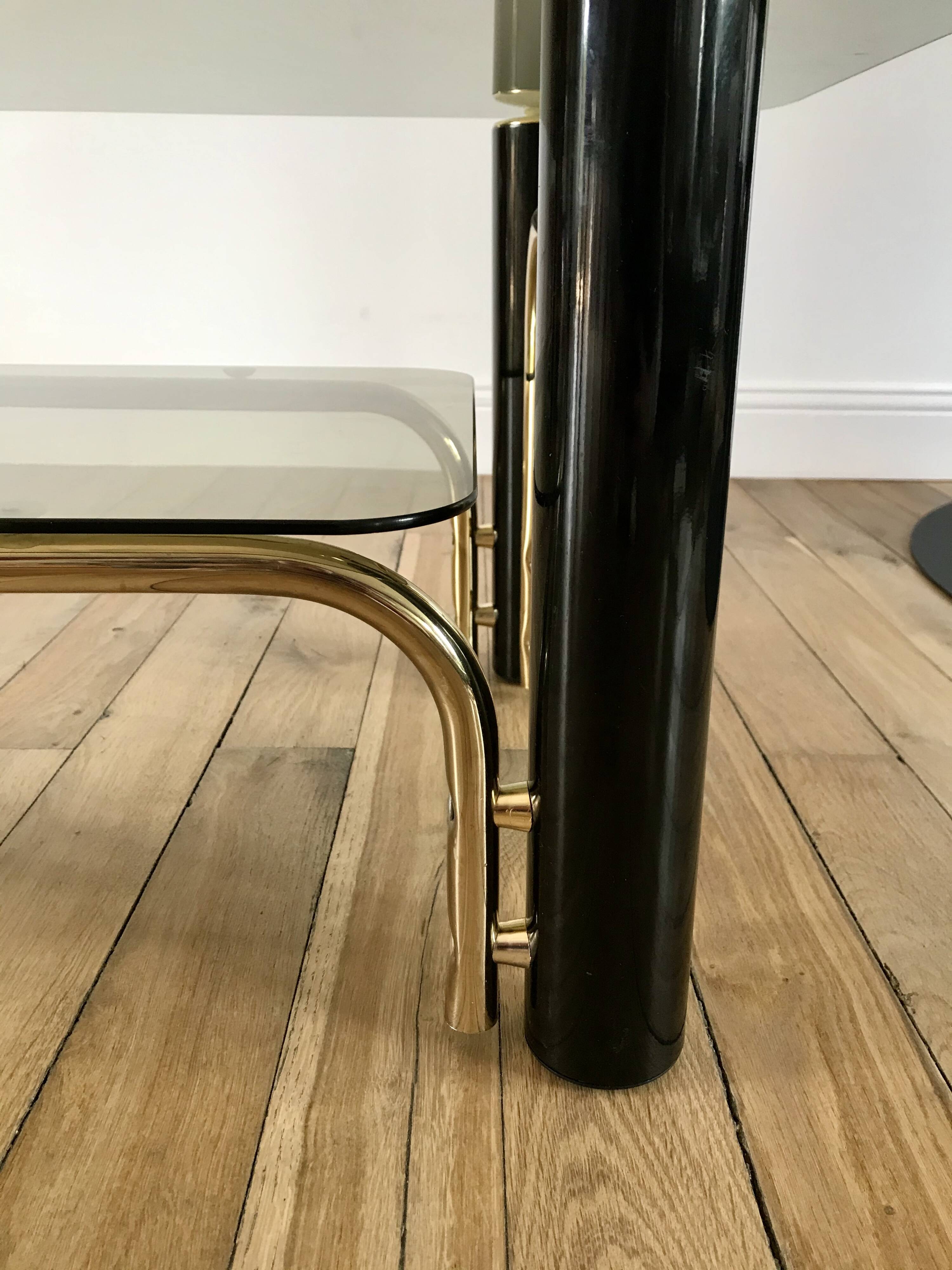 coffee table in smoked glass and black and gold metal from the 70s
