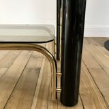 coffee table in smoked glass and black and gold metal from the 70s