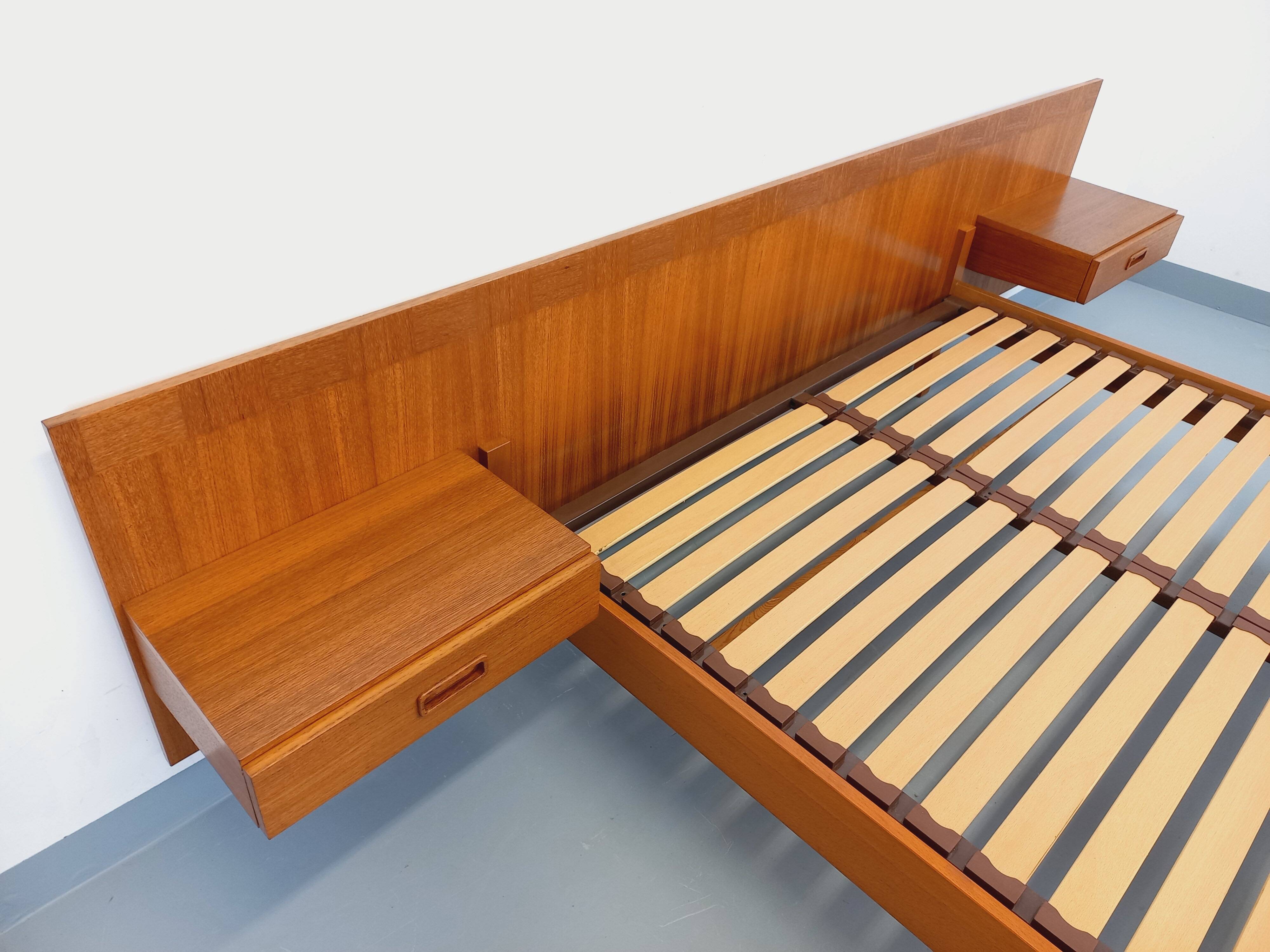 Double bed vintage Scandinavian in teak from the 1960s with integrated bedside tables.