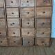 Industrial or apothecary workbench with 30 vintage wooden drawers.