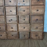 Industrial or apothecary workbench with 30 vintage wooden drawers.